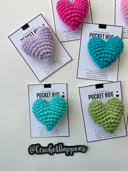 Close up of hand crocheted stuffed pocket hugs hearts collection on gift cards left side